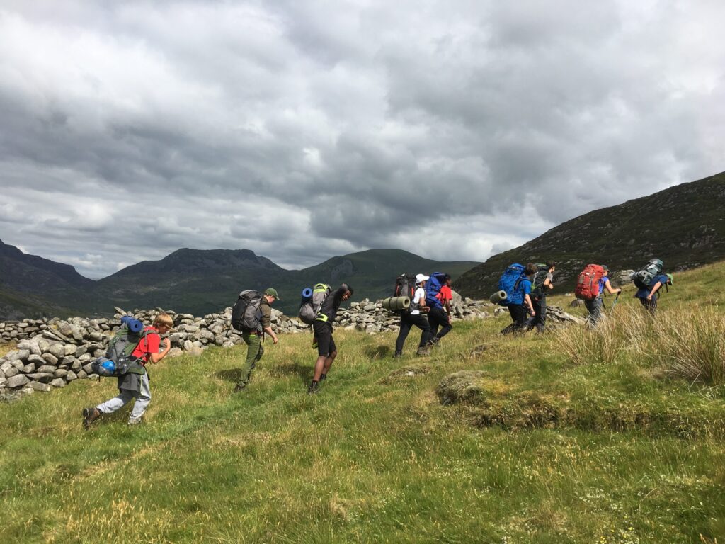 A group of people with backpacks walking