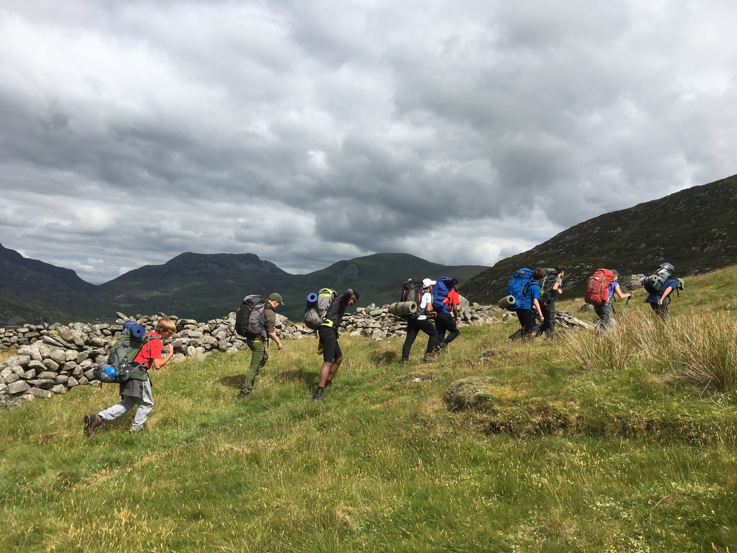 A group of people with backpacks walking