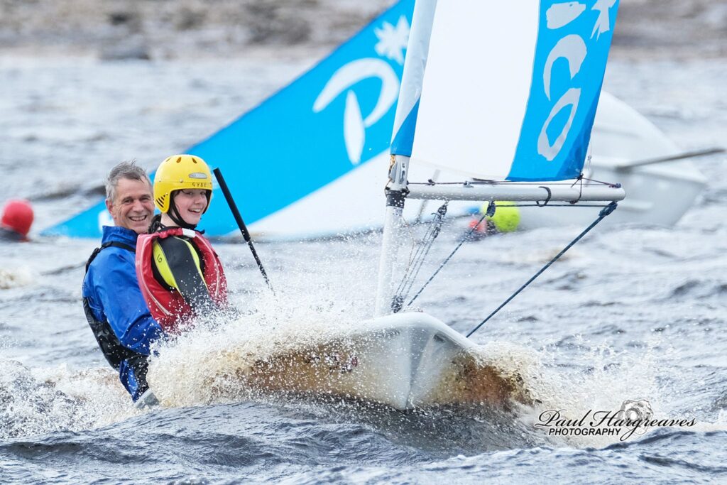 Two sailors enjoying the water in a Pico dinghy