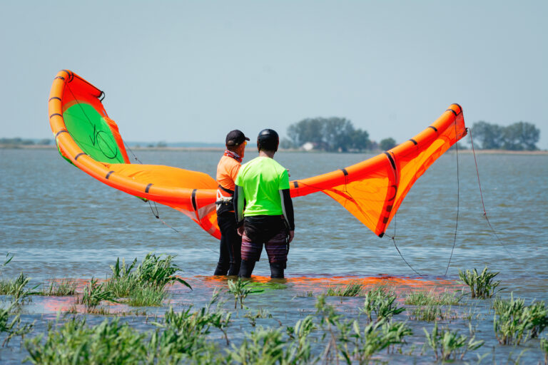 Kitesurfer and instructor on a lake