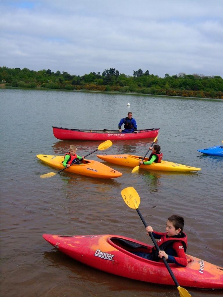 Children with Tim Morton, head of service at Adventure RMS, learning to kayak
