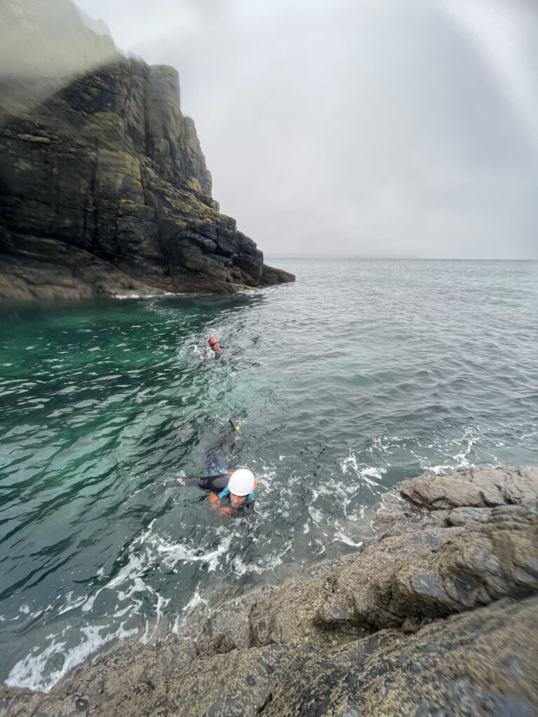 Two individuals in safety gear in the water